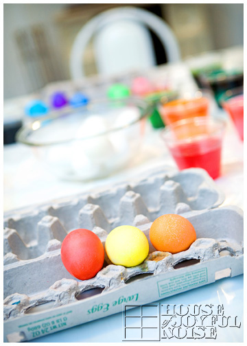 few-colored-easter-eggs-in-carton